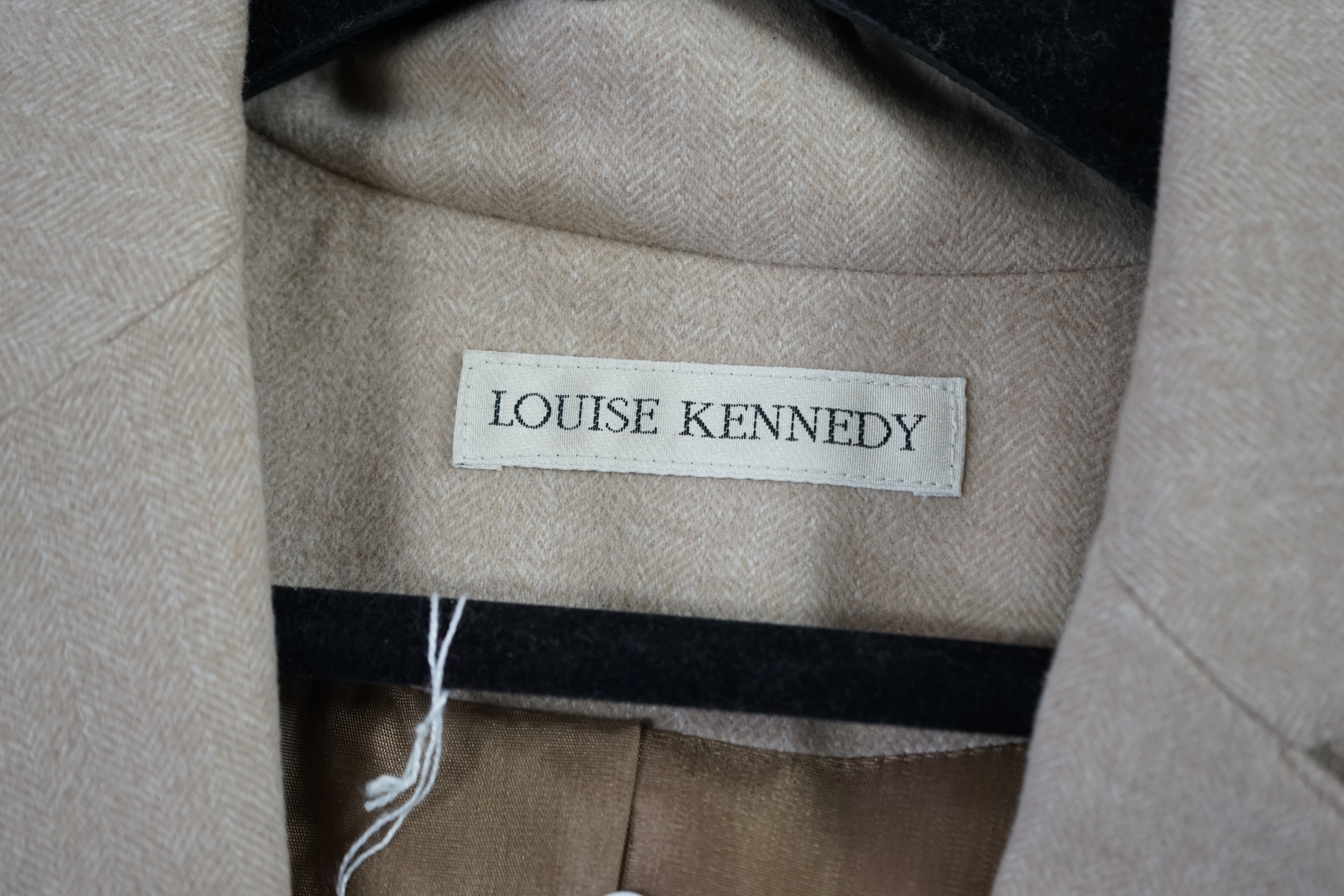 Two Louise Kennedy lady's suits: black with trousers and skirt, taupe long jacket with trousers. Approx size 14 Proceeds to Happy Paws Puppy Rescue